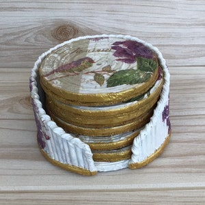 Newspaper coasters with a basket-weave paper case decorated with napkin decoupage. Handmade. Recycled newspaper.