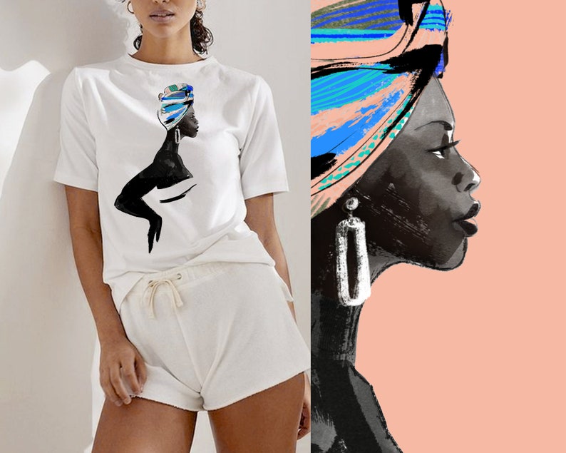 May include: A white t-shirt featuring a black silhouette of a woman wearing a colourful head wrap. The woman is looking to the right. The t-shirt is paired with white shorts.