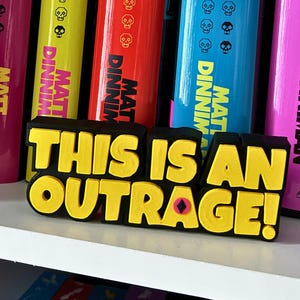 May include: A set of three ceramic mugs with a speckled, matte finish. The mugs are in shades of cream, light gray, and dark gray. Each mug has a simple, minimalist design, perfect for coffee or tea.