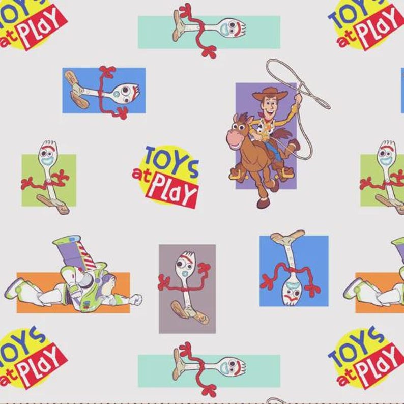 May include: A light gray fabric featuring a repeating pattern of Toy Story characters including Forky, Woody riding Bullseye with a lasso, and Buzz Lightyear. The design includes the text TOYS at Play in colorful, stylized lettering on backgrounds.