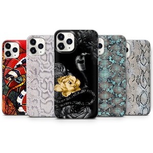 May include: Five different iPhone cases with various snake skin patterns. One case features a black and white snake with a yellow flower. Another case features a colourful snake on a red background. The remaining cases feature different snake skin patterns in shades of grey, blue, and brown.