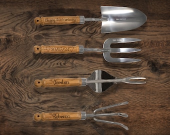 May include: Set of four gardening tools with wooden handles. The handles are engraved with the text "Happy Anniversary", "20/07/24", "Gordon", and "Rebecca".