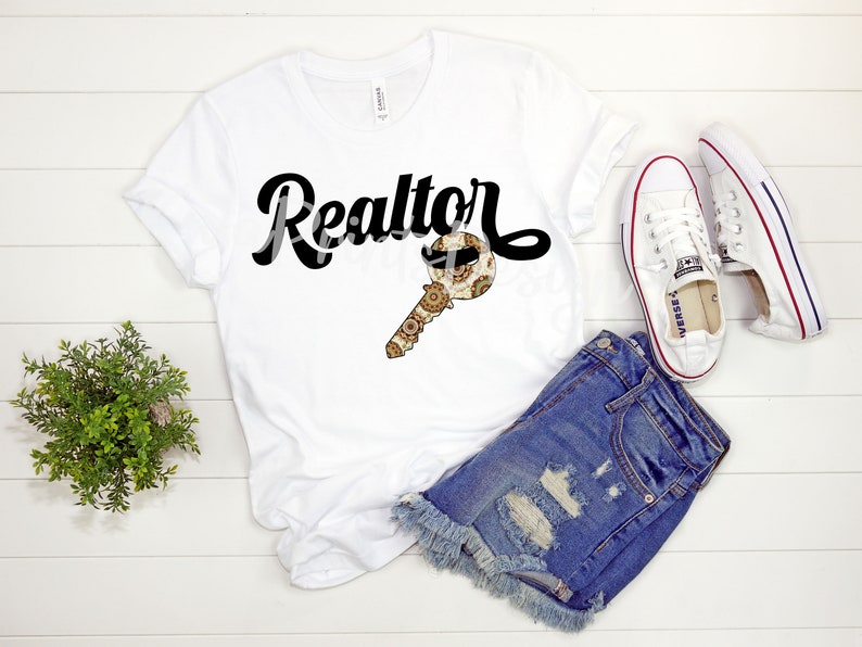 May include: White t-shirt with black text that says "Realtor" and a gold key with a patterned design. The key has a moustache and sunglasses on it.