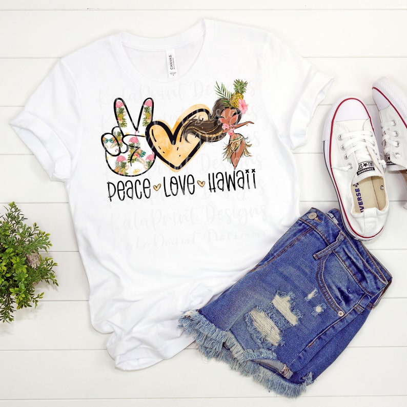 May include: White t-shirt with a peace sign, heart, and a hula girl graphic. The graphic is in black, pink, and yellow. The text "peace love hawaii" is printed below the graphic.