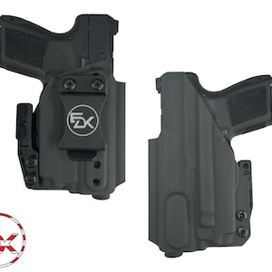May include: A black polymer holster with a clip for carrying a handgun. The holster has a logo that says "FDX" on it.