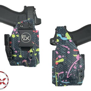 May include: Two black holsters for a handgun, each featuring a carbon fiber texture with a vibrant neon paint splatter pattern in pink, yellow, and blue. One holster includes a black belt clip with a circular FDK logo and black screws.