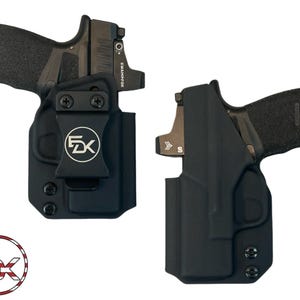 May include: Two black molded holsters, each containing a handgun with a Swampfox optic sight. The left holster features a black belt clip with a circular FDK logo. A circular logo with the letters FDK and an American flag pattern is at the bottom.