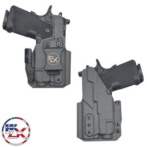 May include: A black molded holster containing a black semi-automatic pistol. The holster features a belt clip with a circular logo displaying the letters FDK. A separate circular logo with the letters FDK and an American flag pattern is included.