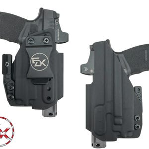 May include: Two black molded holsters, each containing a handgun with a mounted optic sight. The left holster features a black belt clip with a circular logo displaying the letters FDK. The holsters are matte black with visible screws.