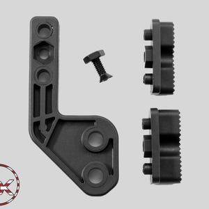 May include: A black L-shaped mounting bracket with multiple circular and hexagonal holes, accompanied by a single black flat-head bolt and two black rectangular clamping blocks featuring serrated edges and integrated hexagonal hardware.