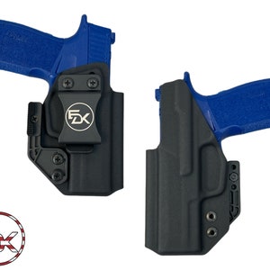 May include: Two black holsters with a blue handgun in each. The holsters have a clip on the side and a button on the front. The holsters are made by 5DK.