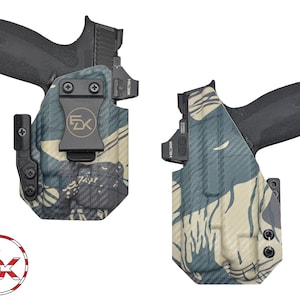May include: Two black handguns are displayed, each holstered in a camouflage pattern holster. The holsters feature a black clip and hardware. The camouflage pattern includes shades of blue, green, and tan. The logo of a company is visible.