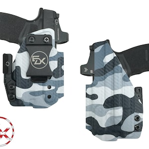 May include: Two black and grey camouflage holsters for a handgun with a black clip and a black screw on the side. The holsters are made of a durable material and are designed to fit a variety of handguns.