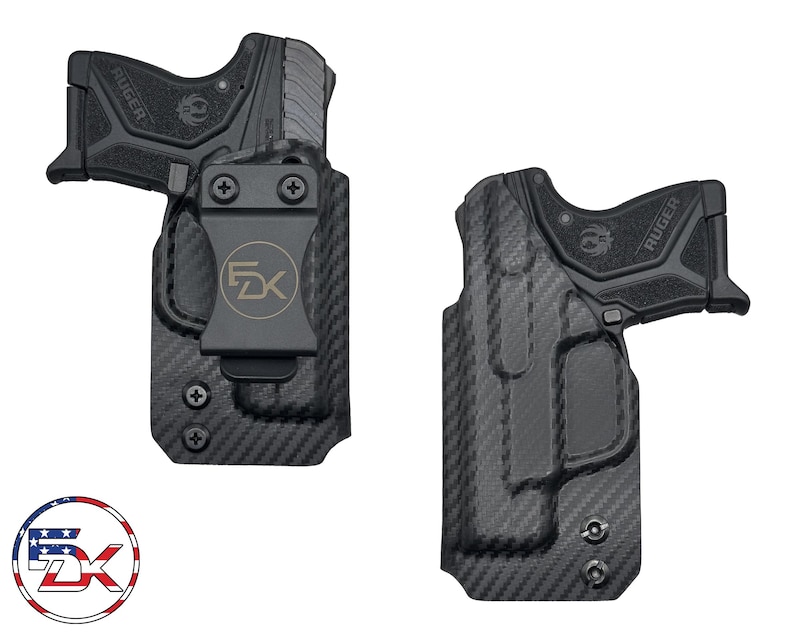 May include: A black carbon fiber holster with a black clip and a black handgun with the word "RUGER" printed on the side. The holster has a logo that says "FDX" on it.