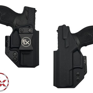 May include: Two black gun holsters with a firearm inside. The holsters have a clip with the letters "5K" and a logo. The firearm is black. The holsters are designed to hold a handgun.