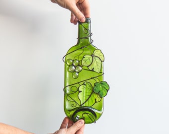 Fused wine glass bottle with grapevines and encircled by coiled grape leaves kitchen decoration