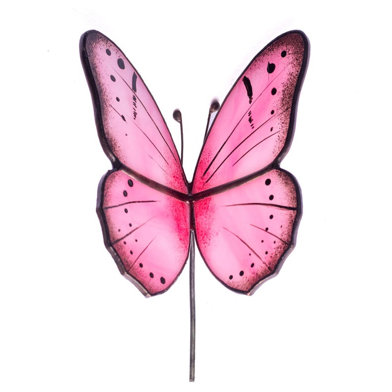 Pink stained glass butterfly garden stake with delicate black detailing, perfect for plant pots or outdoor garden decoration.