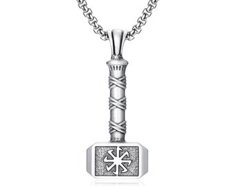May include: Silver-colored pendant necklace featuring a hammer-shaped pendant. The pendant has a detailed design with a wrapped handle and a symbol on the hammerhead. The necklace chain is a matching silver color.