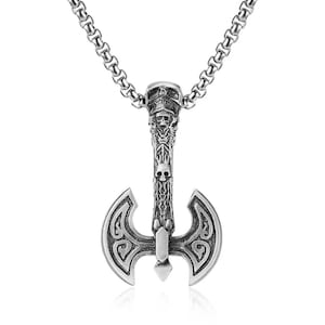 May include: Silver-toned axe pendant necklace. The pendant features a detailed axe design with skull and decorative elements. The necklace has a chain link style and is suitable for everyday wear.