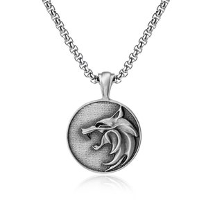 May include: Silver-toned pendant necklace featuring a wolf head design within a circular frame. The pendant hangs from a matching chain. The wolf head is detailed with sharp features and a textured background.