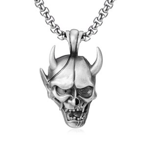 May include: Silver-toned pendant necklace featuring a detailed devil skull design. The pendant has horns, pointed ears, and an open mouth. The chain is a linked style. A gothic or alternative style accessory.