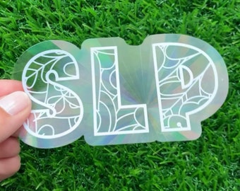 Puede incluir: Una pegatina holográfica con las letras "SLP" en blanco, rodeadas de un diseño floral blanco.