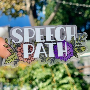 May include: A clear sticker with the words "Speech Path" in white lettering surrounded by colourful floral designs.