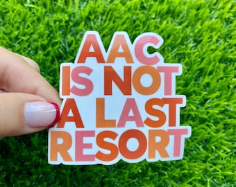 May include: A white sticker with the text "AAC is not a last resort" in pink, orange, and red letters.