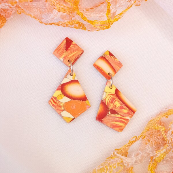 Sun coloured stone look earrings diamond shape.