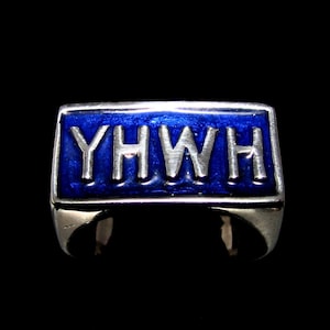May include: A silver ring with a blue enamel band and the word "YHWH" in white lettering.
