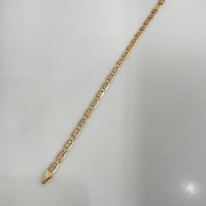 May include: A gold chain bracelet with a tri-color design. The chain is made of three different colors of gold: yellow, white, and rose.