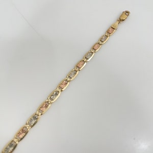 May include: A gold chain bracelet with a tri-color design. The chain is made of interlocking oval links with a textured surface.