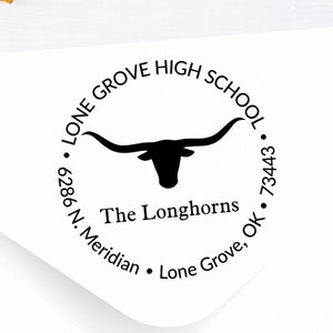May include: A black and white round rubber stamp with the text "Lone Grove High School" and "The Longhorns" with a longhorn steer silhouette in the center. The address is "6286 N. Meridian, Lone Grove, OK 73443."
