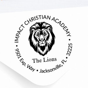 May include: A black and white round return address stamp with the text "Impact Christian Academy" and "The Lions" with a lion head graphic. The address is "9501 Exp. Way, Jacksonville, FL 32225."