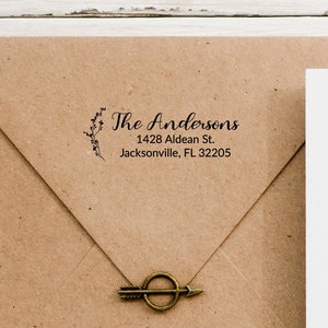 May include: A brown paper envelope with a white envelope inside. The brown envelope has a return address label that reads "The Andersons, 1428 Aldean St., Jacksonville, FL 32205".