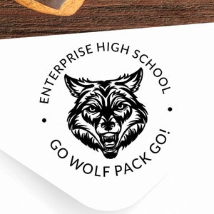 May include: A black and white circular stamp with the text "Enterprise High School" and "Go Wolf Pack Go!" around a wolf head graphic.