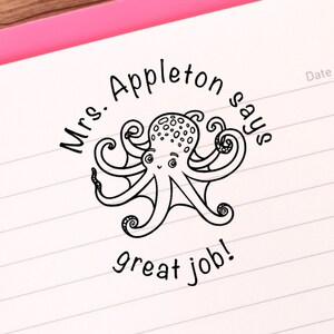 May include: A black and white illustration of an octopus with the text "Mrs. Appleton says great job!" around it.