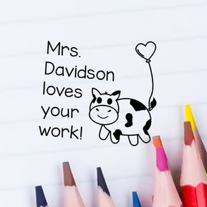 May include: Black and white illustration of a cow with a heart balloon. The text "Mrs. Davidson loves your work!" is written above the cow.