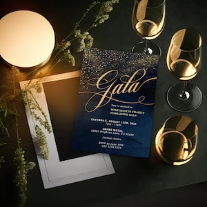 May include: A navy blue invitation with gold glitter accents and the word "Gala" in gold script. The invitation is for a Winchester Charity Fundraising Gala on August 15th, 2023, from 7pm to 11pm at the Shore Hotel. The address and RSVP information are included.