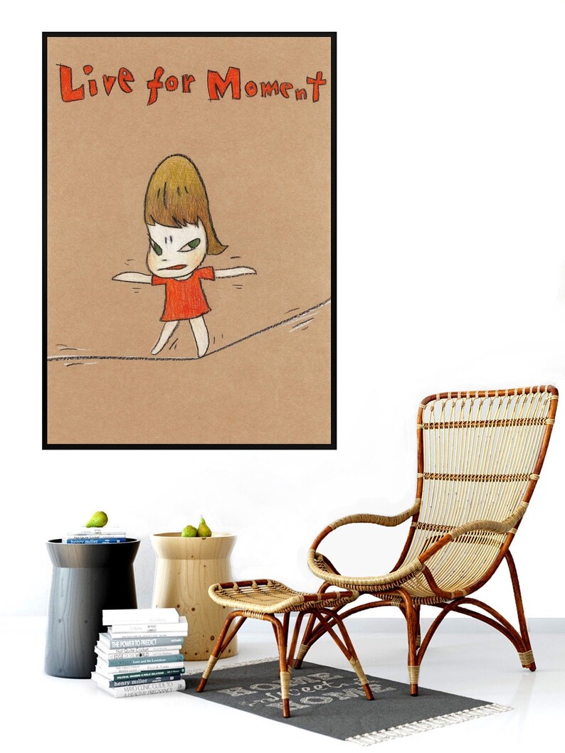 May include: A framed illustration of a cartoon girl in a red dress walking on a tightrope. The text "Live for Moment" is written in red at the top of the image.