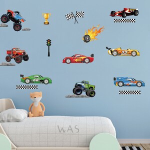 May include: A blue wall with a variety of colorful car and truck decals. The decals include a monster truck, a race car, a pickup truck, and a sports car. There is also a checkered flag, a traffic light, and a trophy.