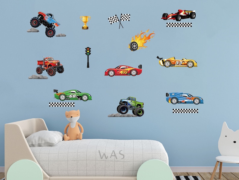 May include: A blue wall with a variety of colorful car and truck decals. The decals include a monster truck, a race car, a pickup truck, and a sports car. There is also a checkered flag, a traffic light, and a trophy.