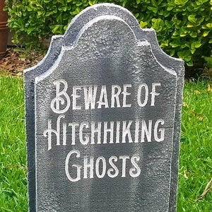 Beware of Hitchhiking Ghosts custom gravestone tombstone. LED Illuminated with 20 color choices. Remote included. Great for Halloween