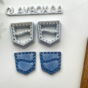 May include: Two white plastic cookie cutters shaped like a jean pocket, and two blue fondant jean pockets.