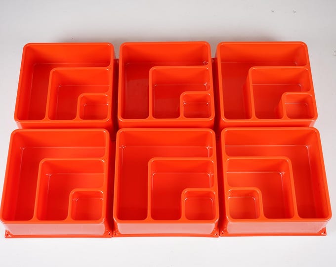 Old vintage orange wall shelf in a space age design from the 70s