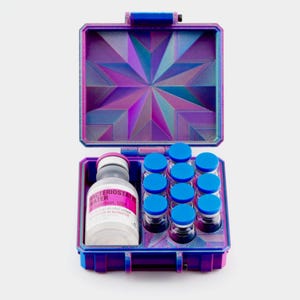 May include: Open, multi-colored case with a geometric design, holding a bottle and several small vials with blue caps. The bottle has a label that reads "Bacteriostat Water". The case is primarily purple and blue.