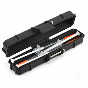 May include: Black rectangular case with an open lid, revealing two syringes with white plungers and orange caps. The case has a secure latch and is designed for storage and protection of medical supplies.
