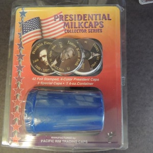May include: A plastic package containing a set of 42 foil-stamped, 4-color presidential milk caps, 3 special caps, and a 14-ounce container. The package features a red, white, and blue American flag and stars. The milk caps feature images of presidents Franklin Pierce, James Knox Polk, and others.