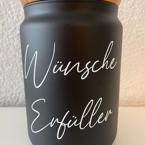 May include: Black ceramic jar with a bamboo lid. The jar has white lettering that says "W&uuml;nsche Erf&uuml;ller".