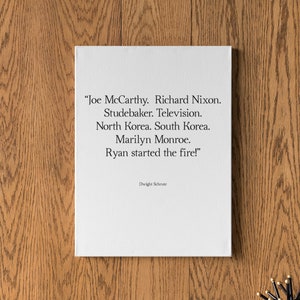 Puede incluir: Una impresión en lienzo blanco con una cita en blanco y negro de Dwight Schrute de la serie de televisión "The Office". La cita dice: "Joe McCarthy. Richard Nixon. Studebaker. Televisión. Corea del Norte. Corea del Sur. Marilyn Monroe. Ryan comenzó el fuego!"